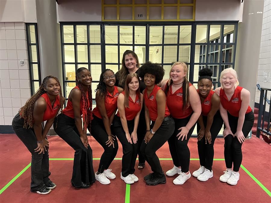 The Cheer Team poses and smiles to camera. 